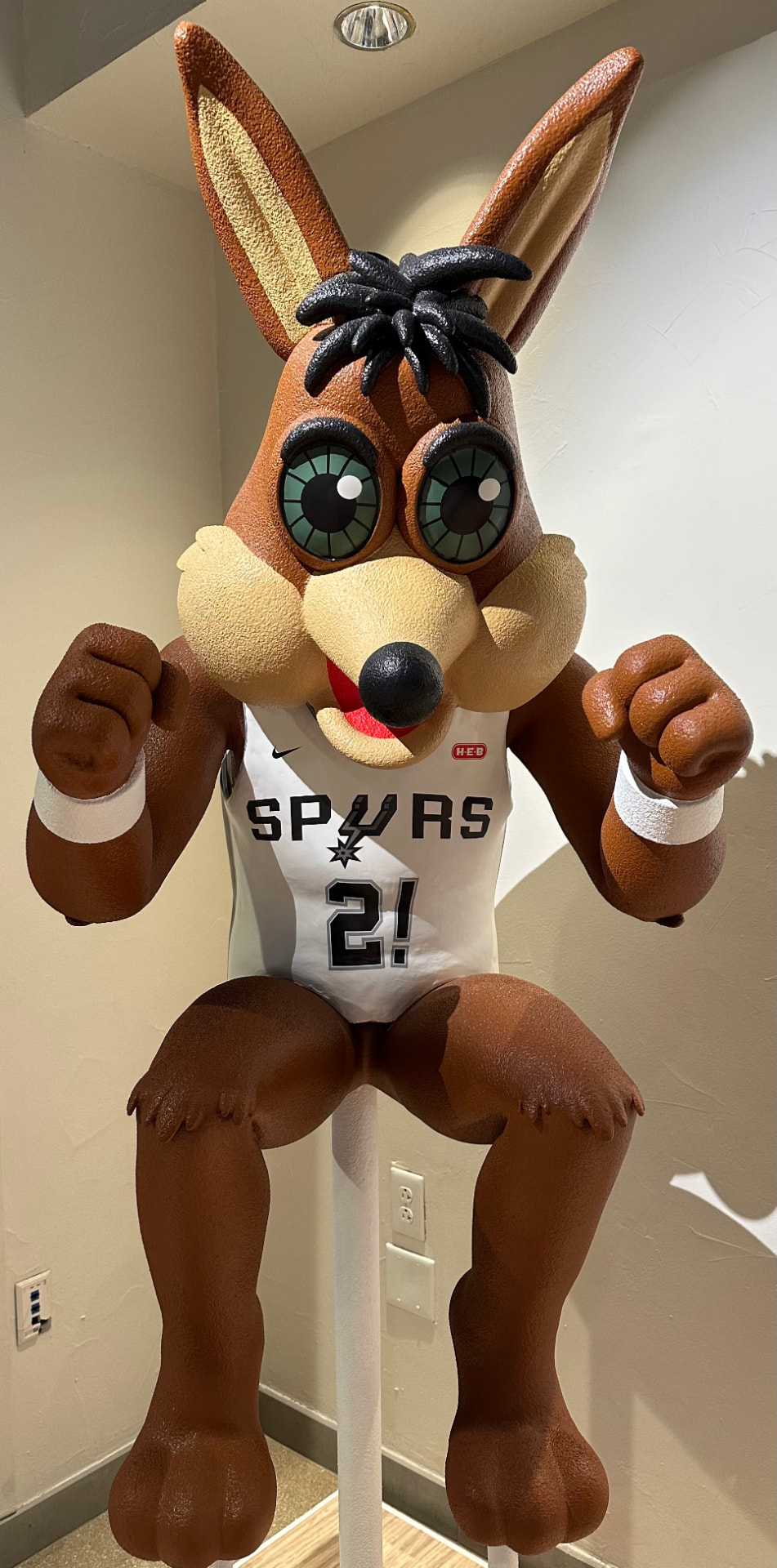 The San Antonio Spurs Coyote mascot statue wearing a white Spurs jersey
