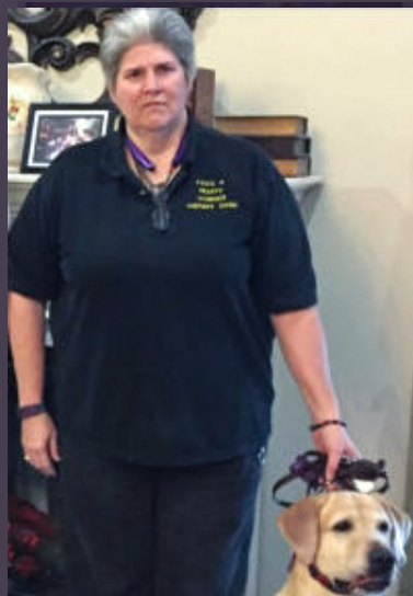 Karen with a yellow Lab therapy dog